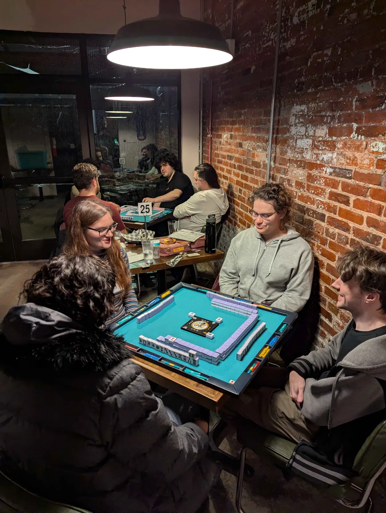 Riichi mahjong players enjoying a casual game at No Land Beyond in Baltimore, MD