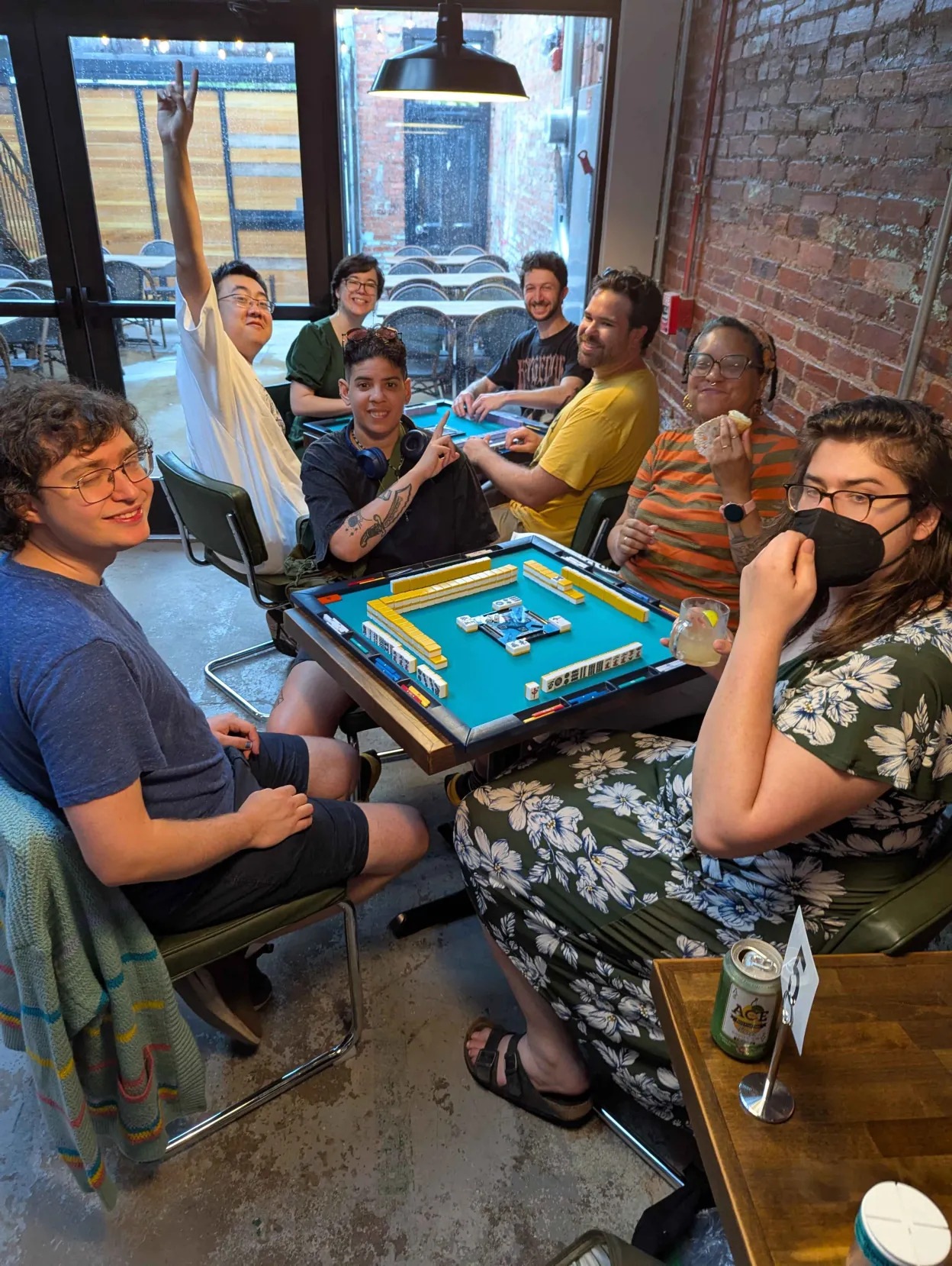 A large group of Charm City Riichi players smiling together at a mahjong meetup in Baltimore